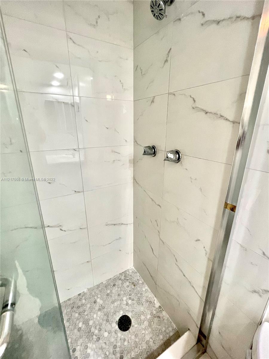 3150 North Course Lane, Unit 107 Pompano Beach, FL 33069 - Photo 12 of 24 a bathroom with a shower