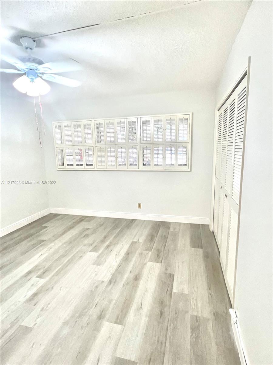 3150 North Course Lane, Unit 107 Pompano Beach, FL 33069 - Photo 14 of 24 a view of an empty room and window