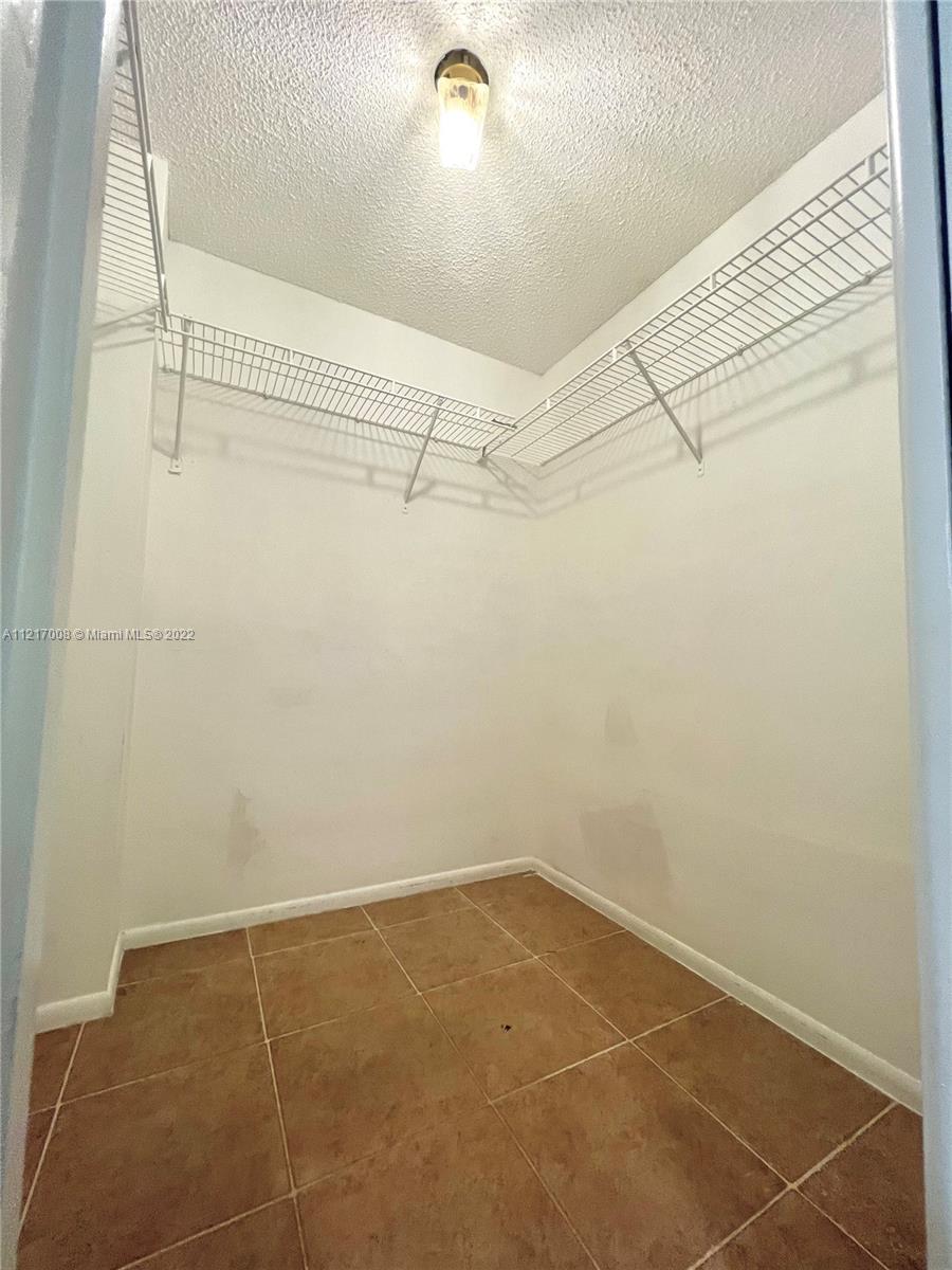 3150 North Course Lane, Unit 107 Pompano Beach, FL 33069 - Photo 18 of 24 a view of a room with racks on the wall