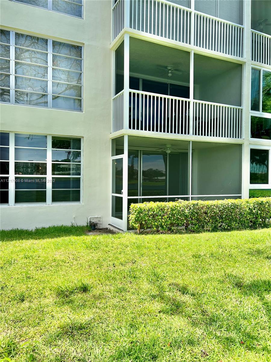3150 North Course Lane, Unit 107 Pompano Beach, FL 33069 - Photo 21 of 24 a view of a house with a yard