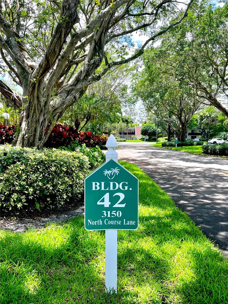 3150 North Course Lane, Unit 107 Pompano Beach, FL 33069 - Photo 22 of 24 a sign that is sitting in the middle of a park