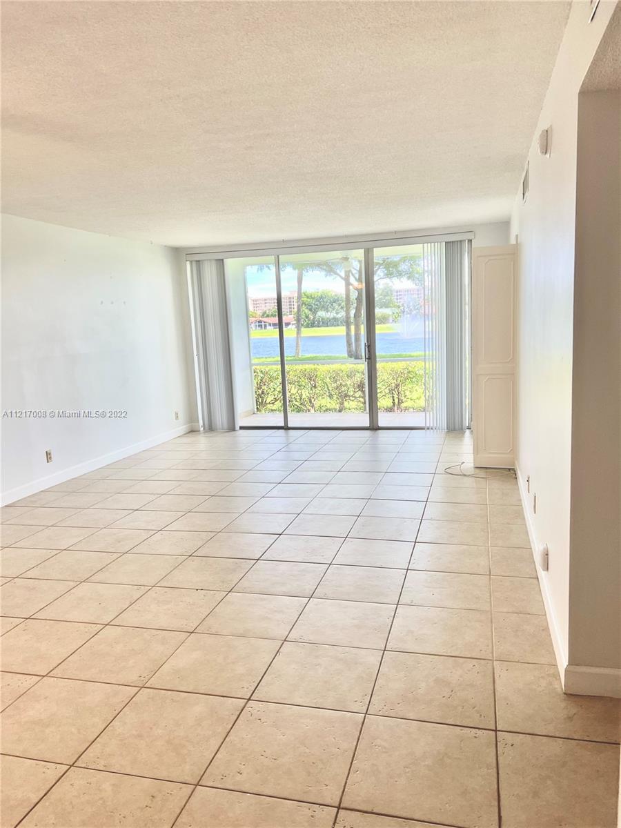 3150 North Course Lane, Unit 107 Pompano Beach, FL 33069 - Photo 5 of 24 a view of an empty room and window