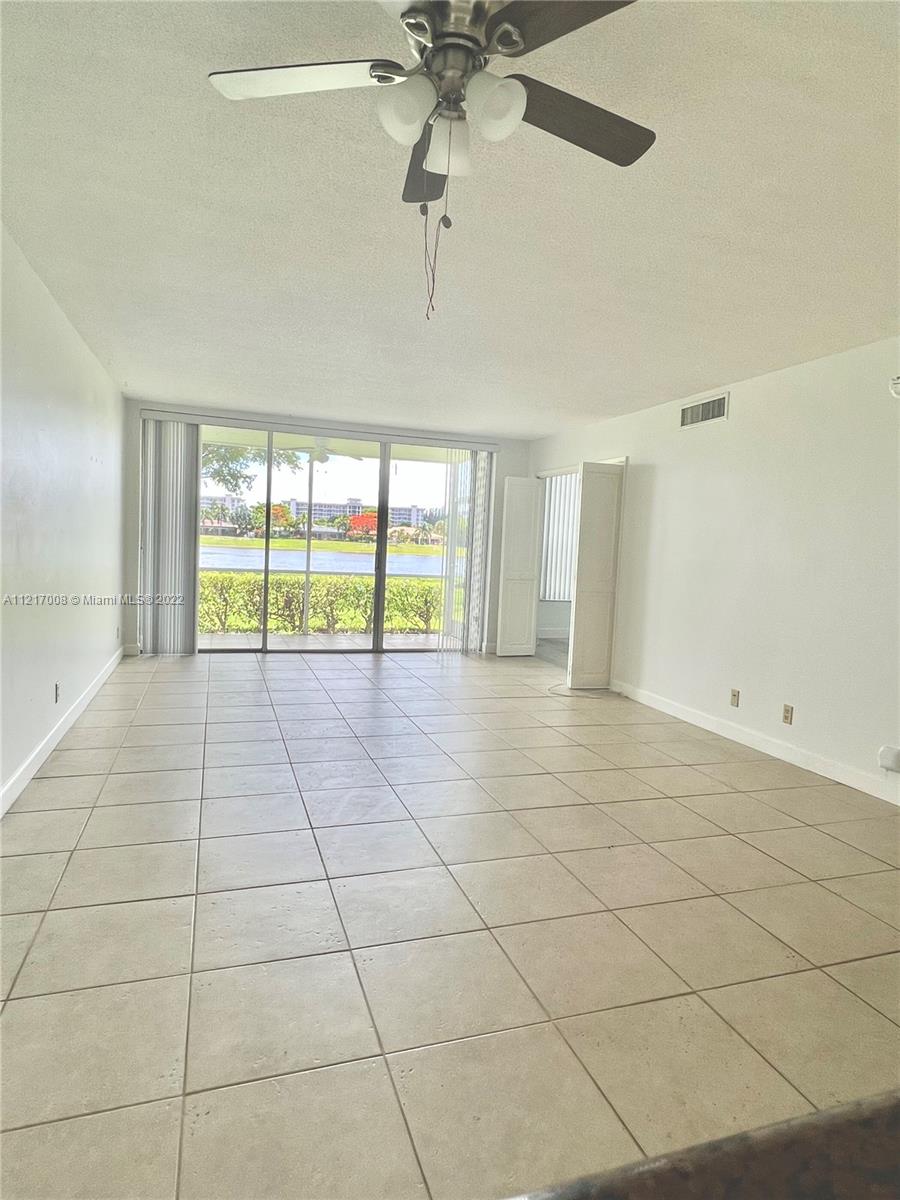 3150 North Course Lane, Unit 107 Pompano Beach, FL 33069 - Photo 6 of 24 a view of an empty room and window