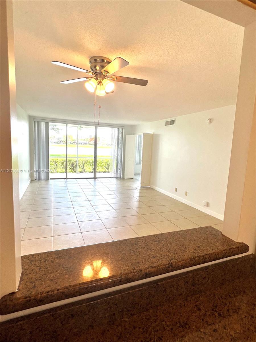 3150 North Course Lane, Unit 107 Pompano Beach, FL 33069 - Photo 9 of 24 a view of an empty room and window