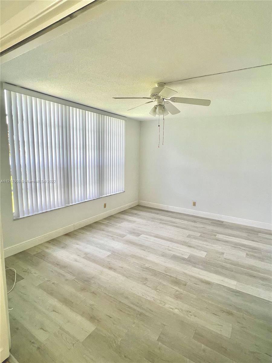 3150 North Course Lane, Unit 107 Pompano Beach, FL 33069 - Photo 10 of 24 a view of a room with an empty space