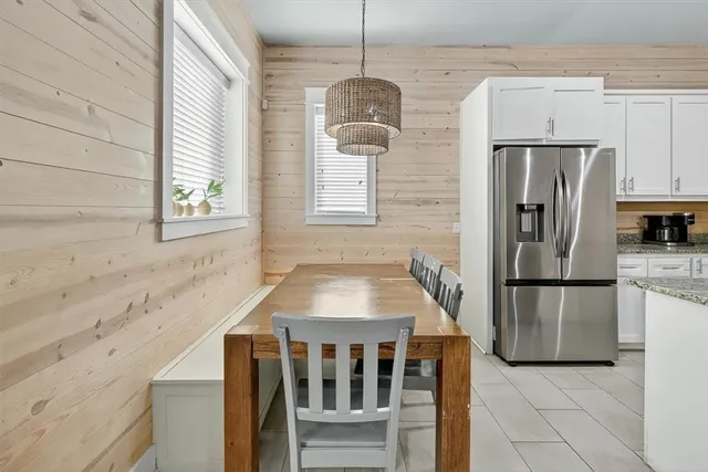 a kitchen with stainless steel appliances granite countertop a refrigerator a stove a sink and a window