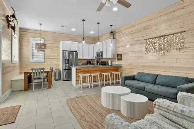 a living room with furniture a dining table and chairs