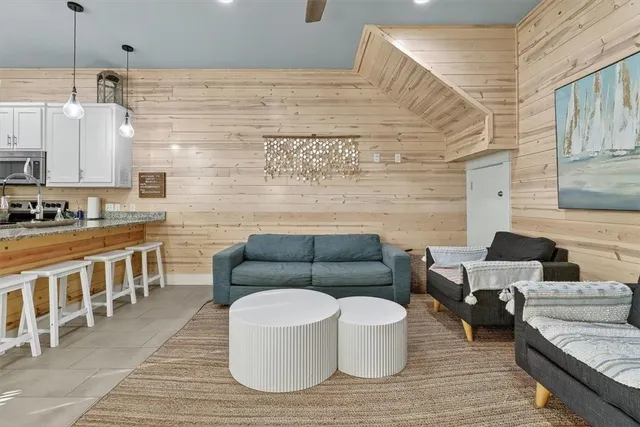 a living room with furniture wooden floor and a window