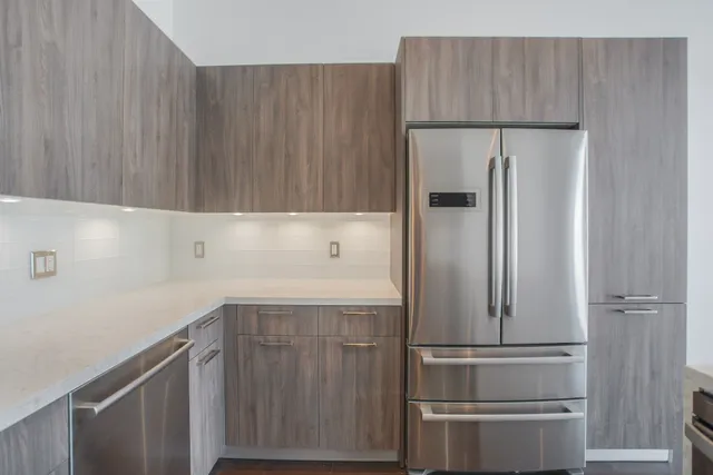 a kitchen with a refrigerator and cabinets