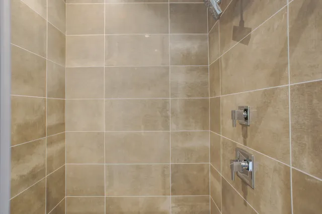 a spacious bathroom with a granite countertop sink and a bathtub