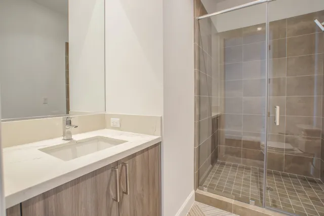 a bathroom with a shower and a sink