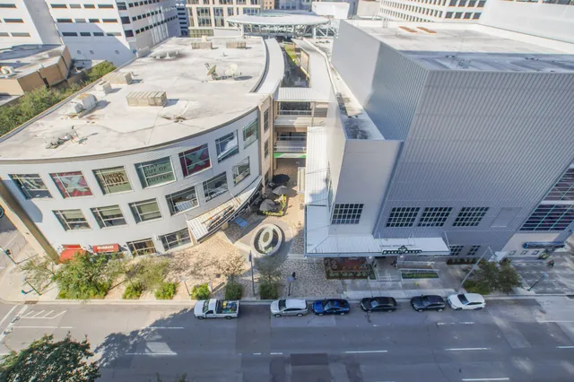 a picture of a building with a lot of cars parked