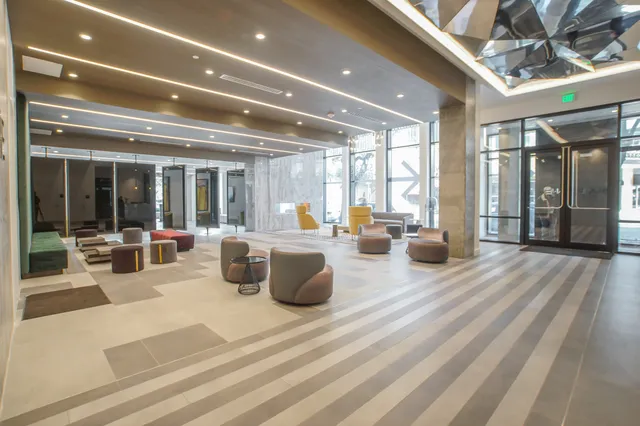 a lobby with furniture and floor to ceiling window