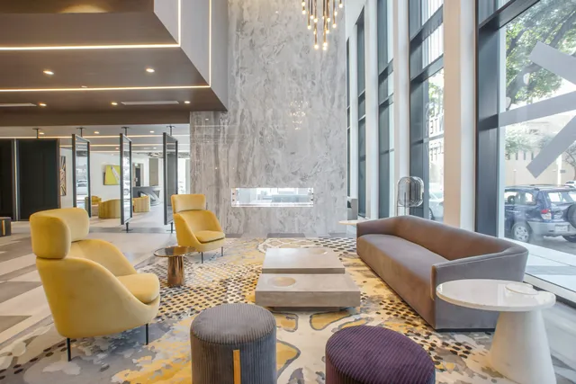 a living room with furniture and a floor to ceiling window