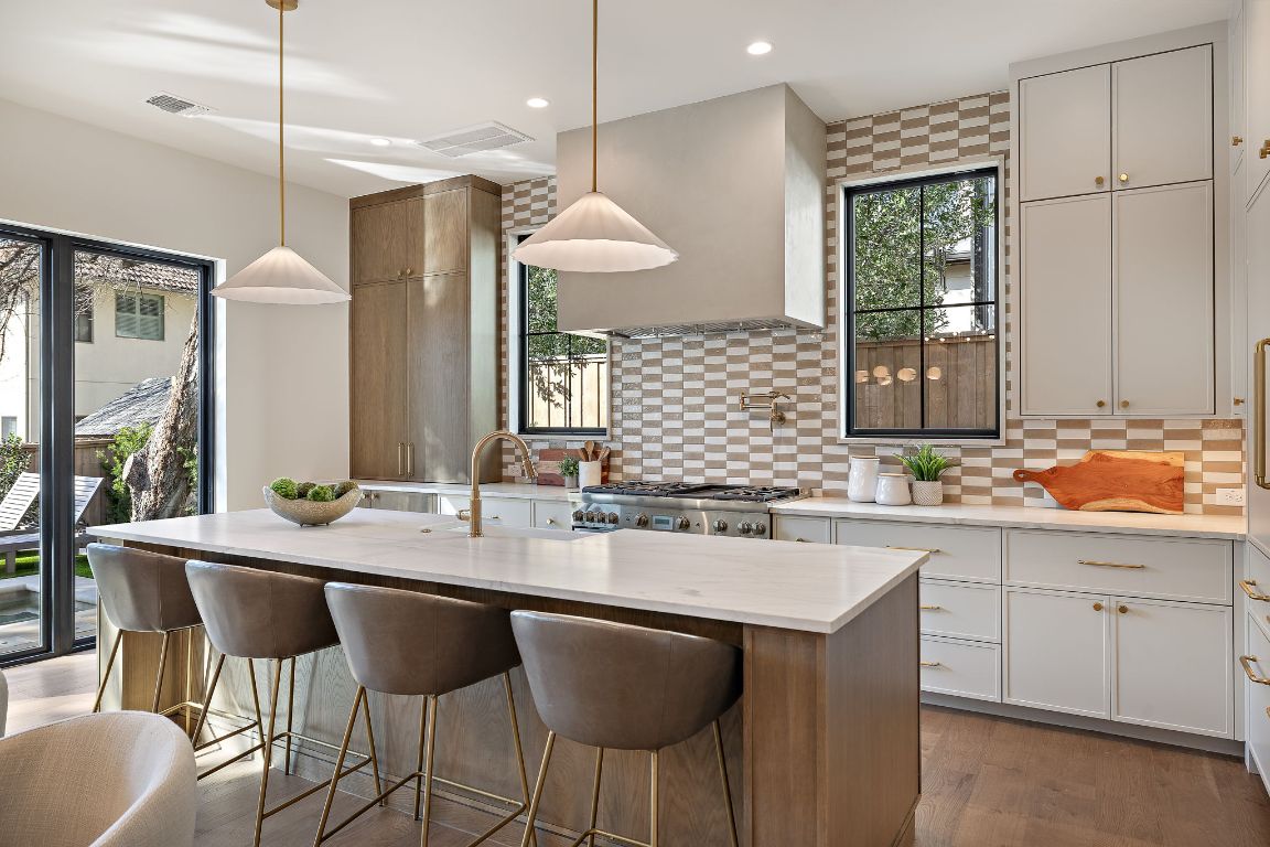 2705 Warren Street Austin, TX 78703 - Photo 11 of 39 a kitchen with center island table and chairs in it