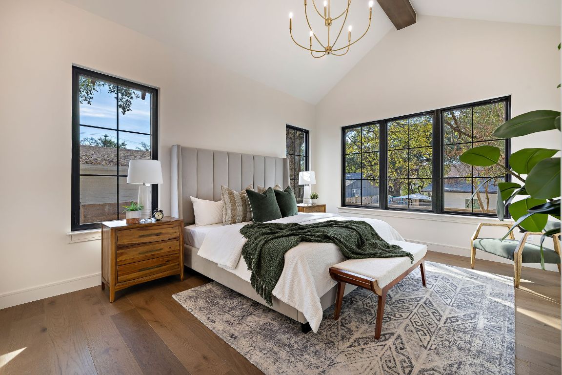 2705 Warren Street Austin, TX 78703 - Photo 18 of 39 a bedroom with a bed a chandelier and a window