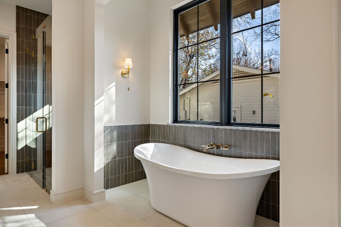 2705 Warren Street Austin, TX 78703 - Photo 19 of 39 a bathroom with a bathtub and a window