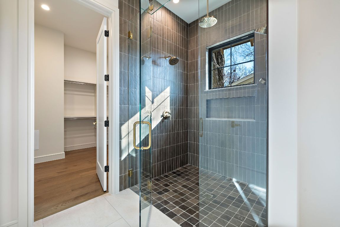 2705 Warren Street Austin, TX 78703 - Photo 21 of 39 a bathroom with a glass shower door