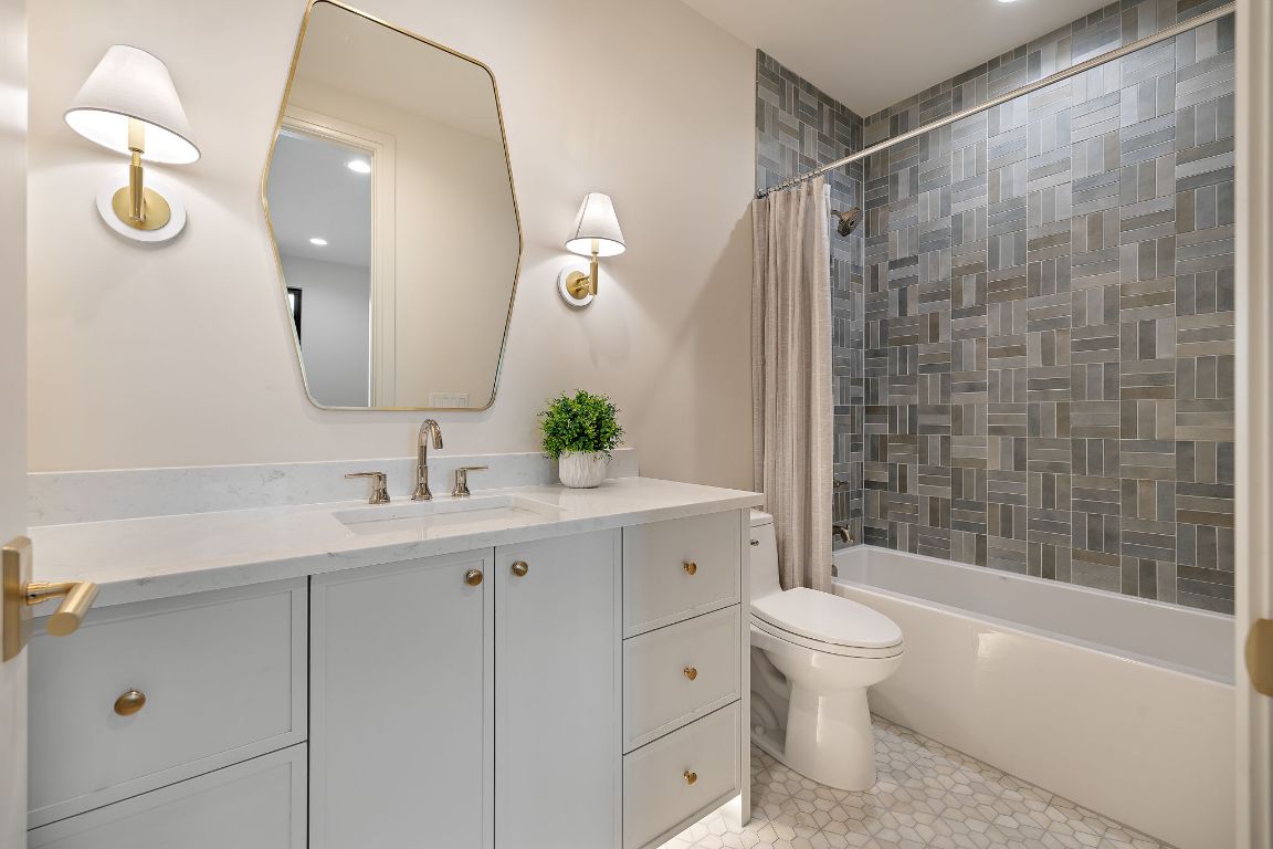 2705 Warren Street Austin, TX 78703 - Photo 28 of 39 a bathroom with a toilet a sink a tub and mirror