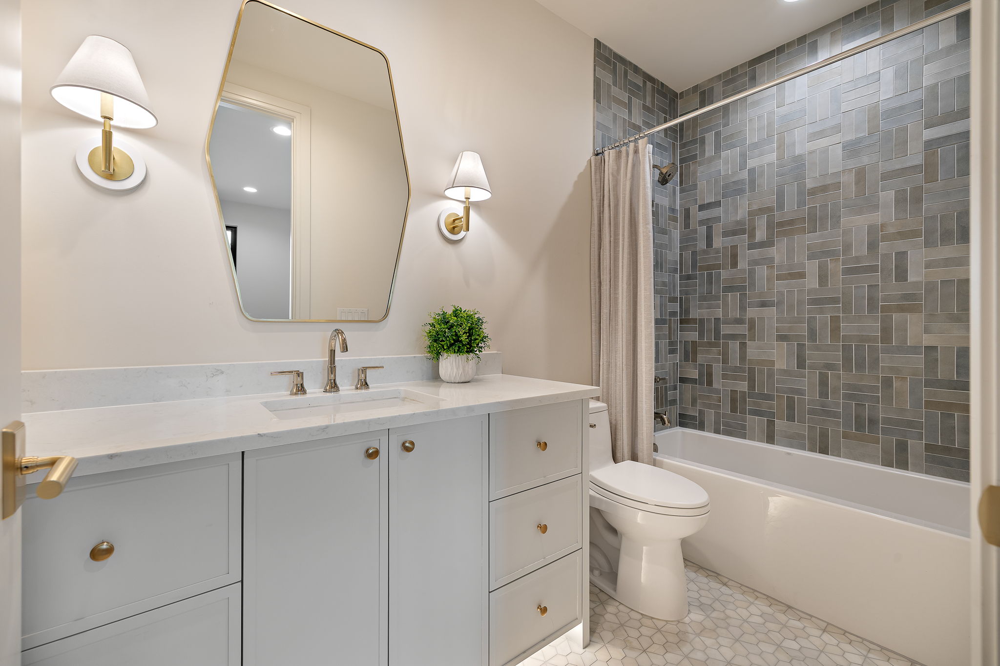 2705 Warren Street Austin, TX 78703 - Photo 28 of 39 a bathroom with a toilet a sink a tub and mirror