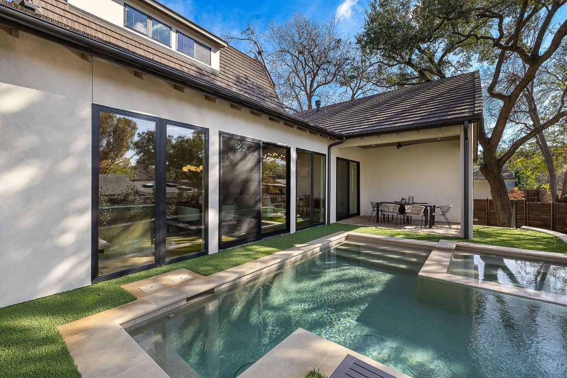 2705 Warren Street Austin, TX 78703 - Photo 39 of 39 a view of a patio with table and chairs and floor to ceiling window with wooden fence