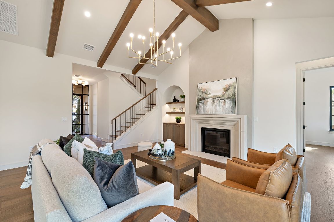 2705 Warren Street Austin, TX 78703 - Photo 6 of 39 a living room with furniture a fireplace and a chandelier