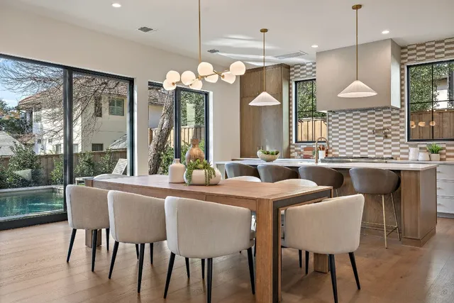 a view of a dining room with furniture a chandelier and wooden floor