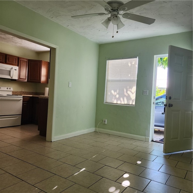 a view of a kitchen with fridge and dishwasher windows