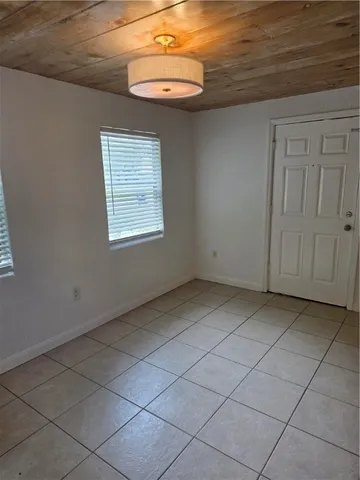 a view of a livingroom with an empty space and a window