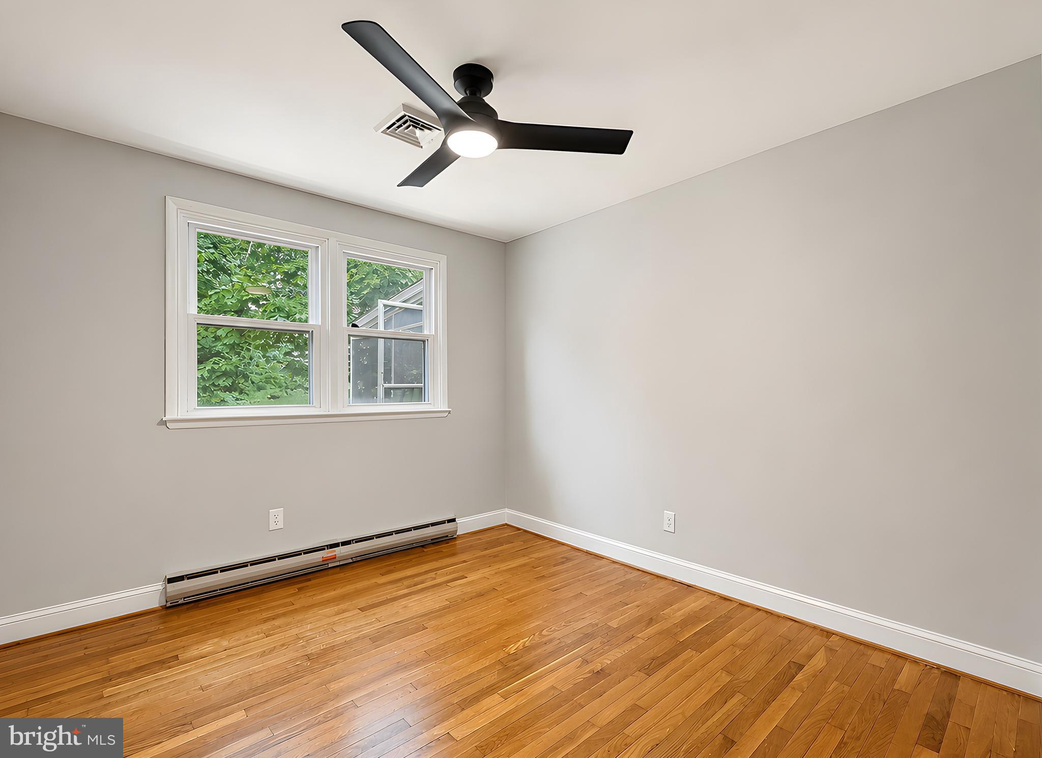 17248 Gum Landing Road St. Inigoes, MD 20684 - Photo 17 of 56 wooden floor in an empty room with a window