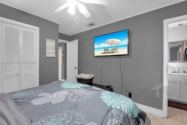 a bedroom with a bed and a painting on the wall