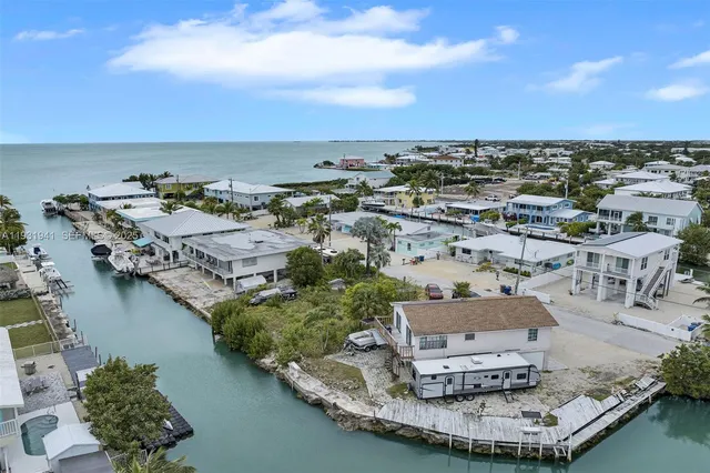 an aerial view of a house with a lake view