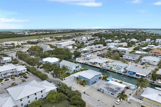 an aerial view of a city with lots of residential buildings in ocean