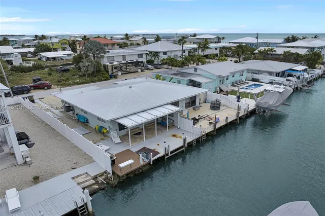 an aerial view of a house with a ocean view