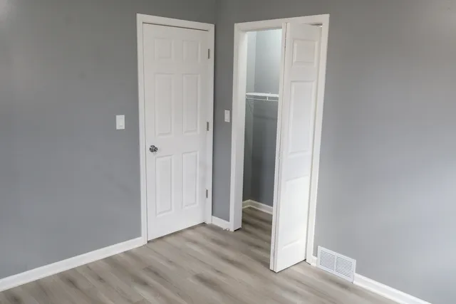 a view of a hallway with wooden floor