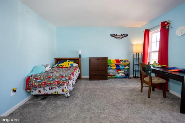 a hallway with wooden floor windows and stairs