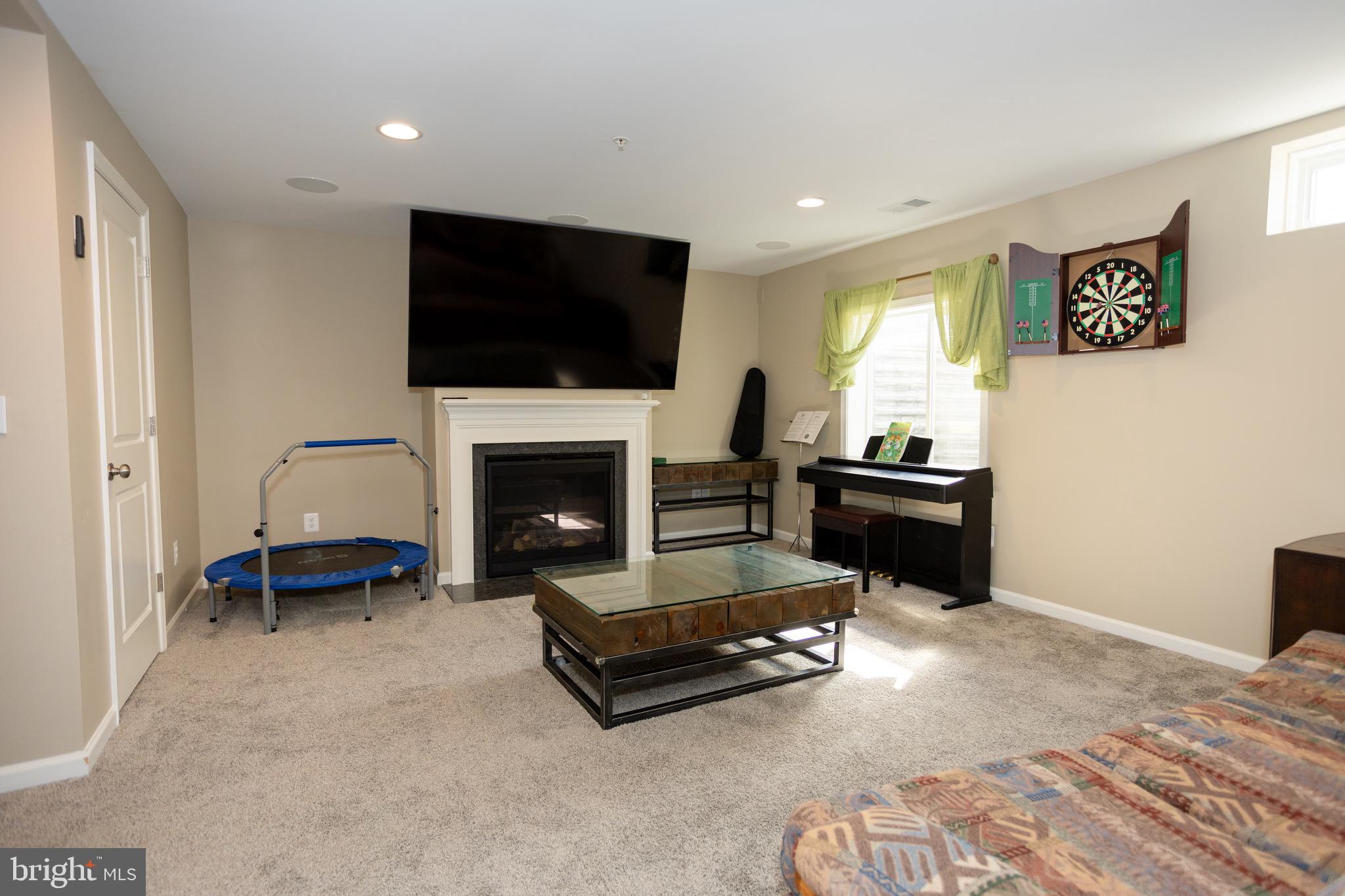 2425 Morgans Point Drive Dumfries, VA 22026 - Photo 28 of 99 a living room with furniture flat screen tv and a fireplace
