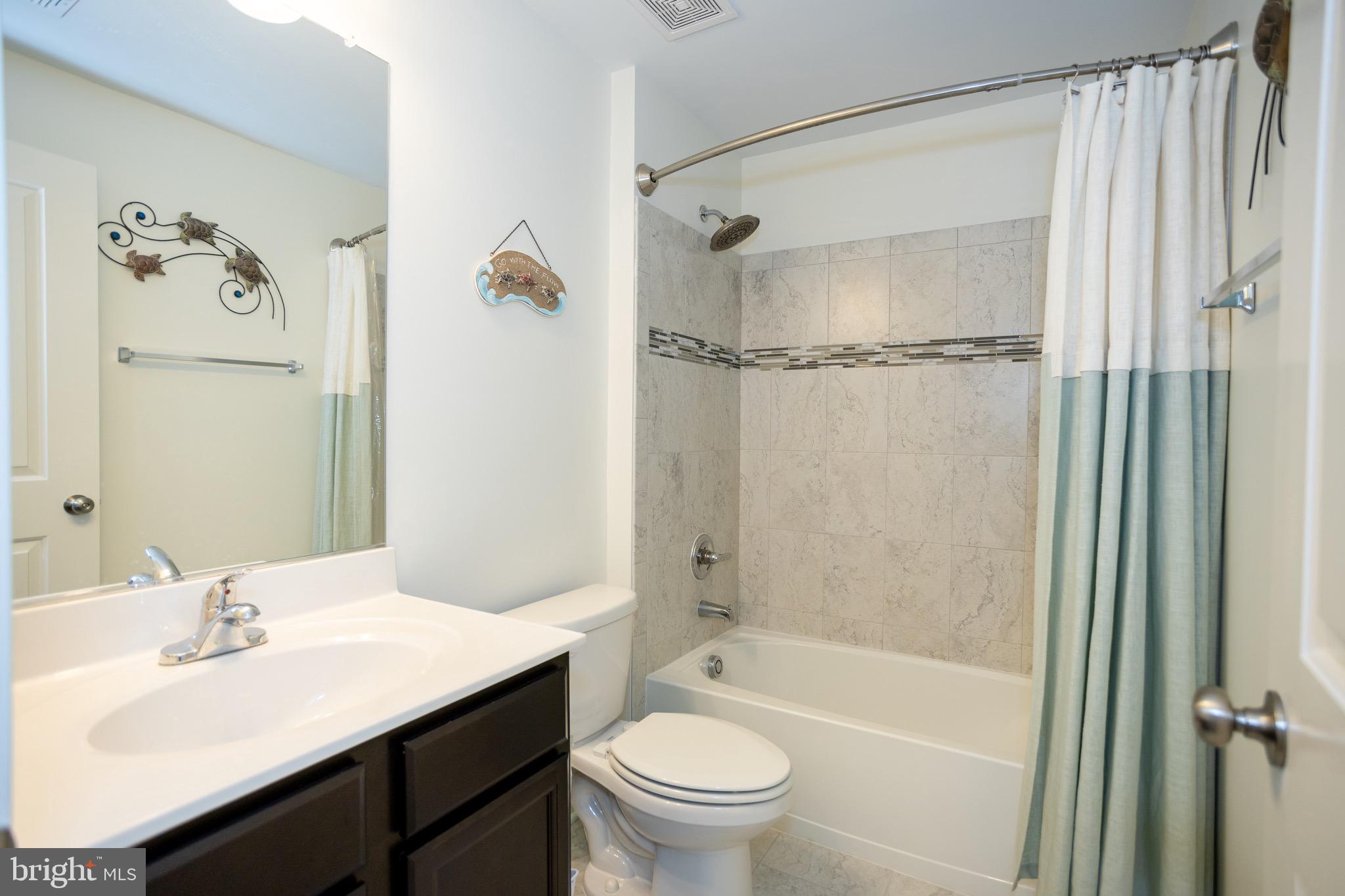2425 Morgans Point Drive Dumfries, VA 22026 - Photo 30 of 99 a bathroom with a sink a toilet and a mirror