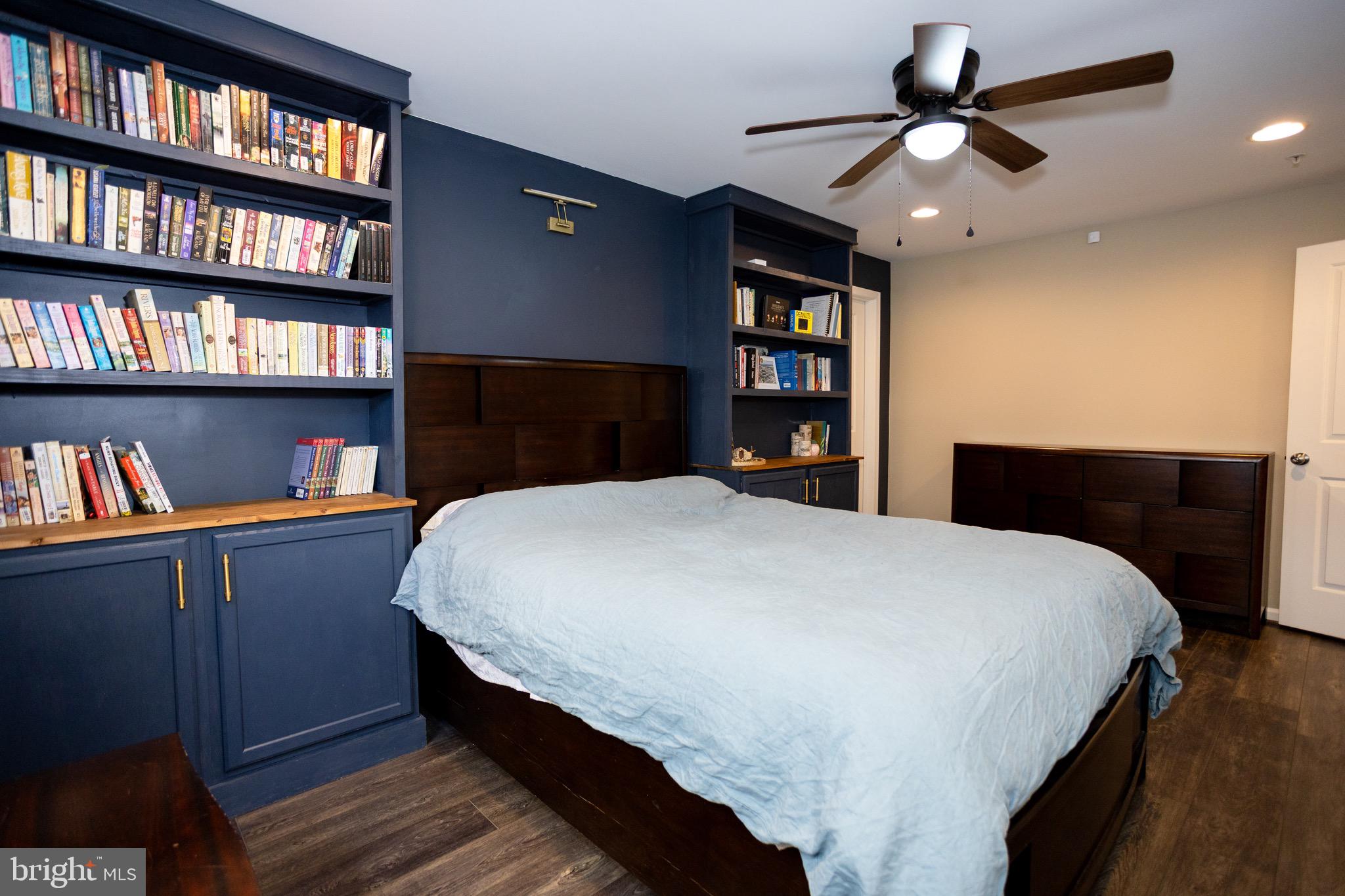 2425 Morgans Point Drive Dumfries, VA 22026 - Photo 33 of 99 a bedroom with a bed a dresser and a book shelf