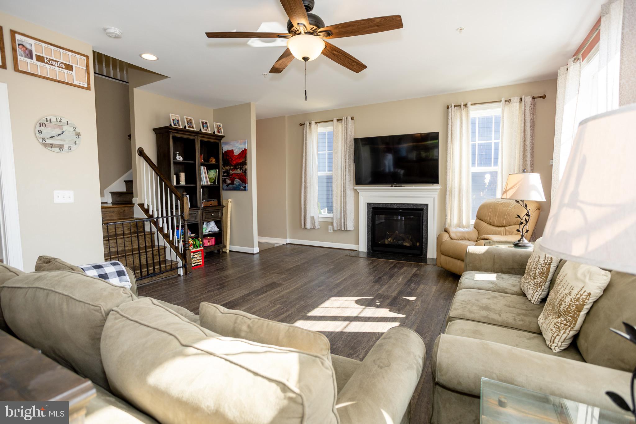 2425 Morgans Point Drive Dumfries, VA 22026 - Photo 35 of 99 a living room with furniture a flat screen tv and a fireplace