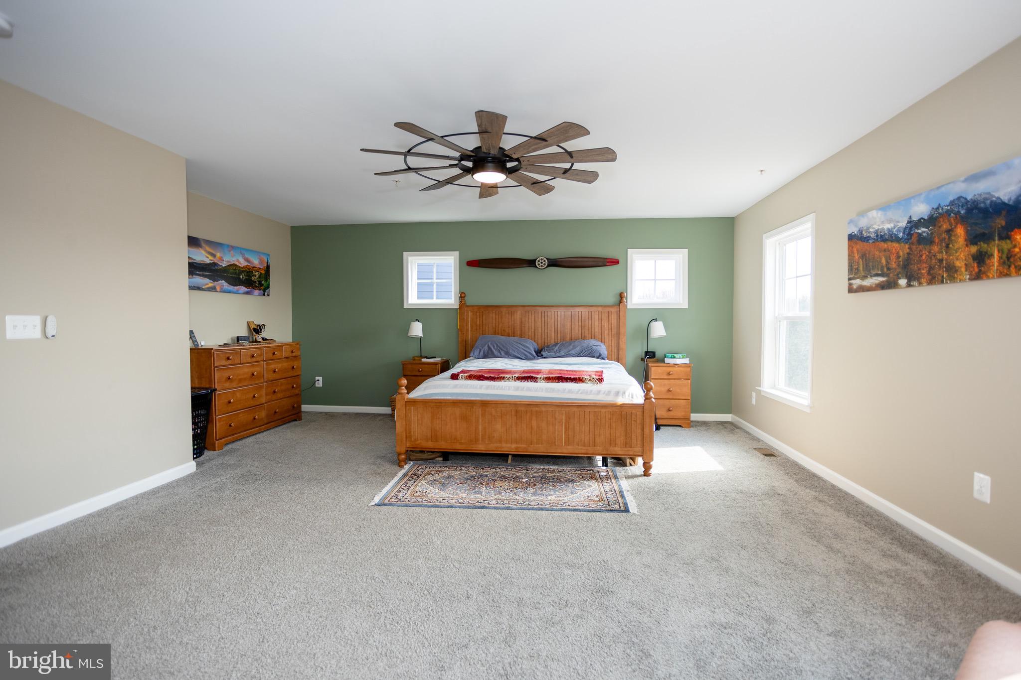 2425 Morgans Point Drive Dumfries, VA 22026 - Photo 44 of 99 a bedroom with a bed and a chandelier