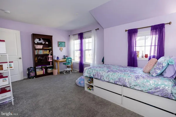 a view of a house with backyard and trees