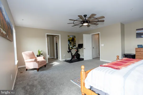 a bedroom with furniture and a book shelf
