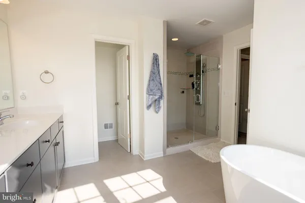 a spacious bedroom with a bed and a window