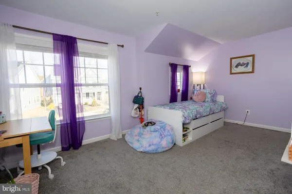 a bedroom with a bed and a bookshelf