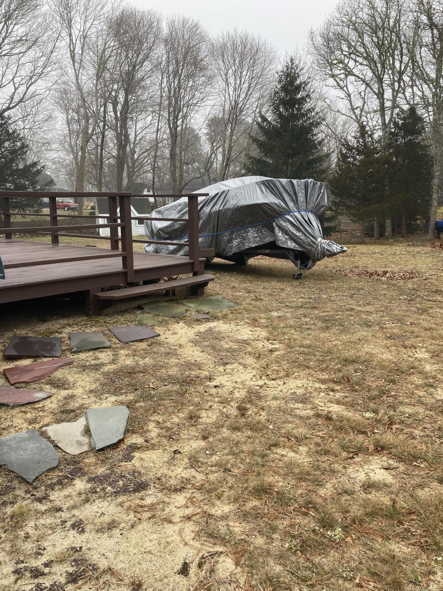 45 Shell Lane Cotuit, MA 02635 - Photo 5 of 6 a view of a backyard with wooden fence
