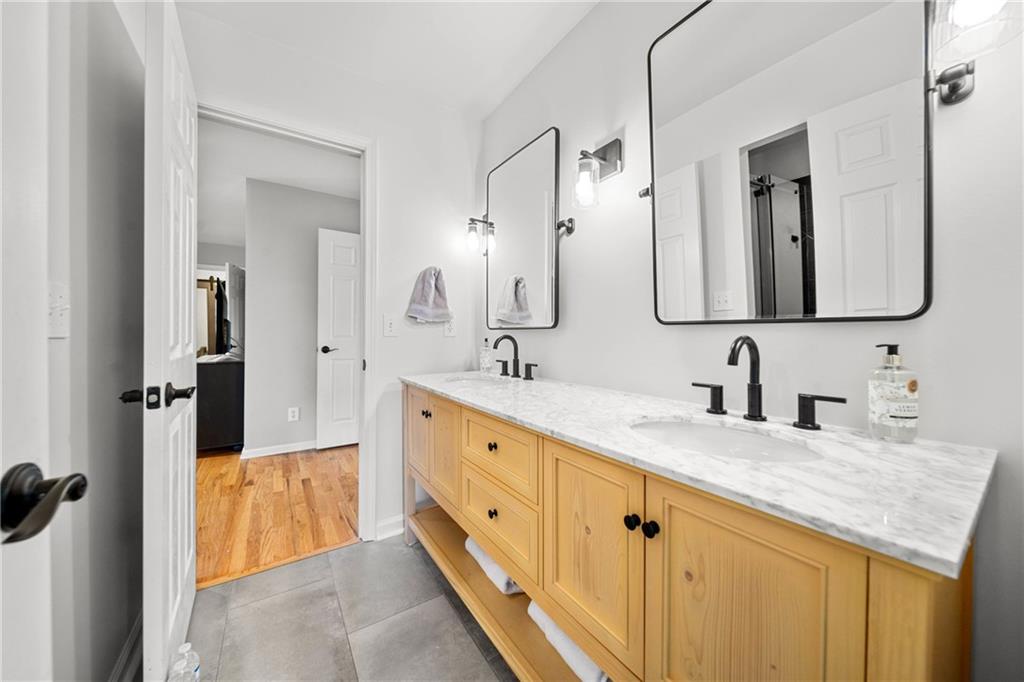 7105 Sheffield Place Cumming, GA 30040 - Photo 23 of 73 a spacious bathroom with double sink and a mirror