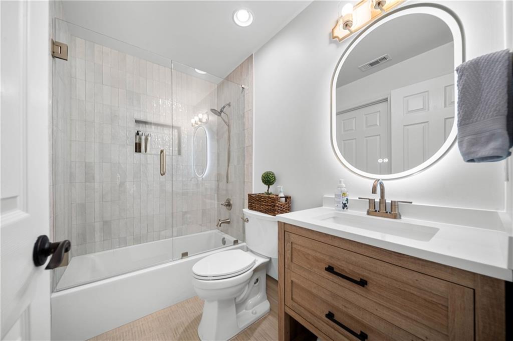 7105 Sheffield Place Cumming, GA 30040 - Photo 29 of 73 a bathroom with a sink a toilet and a mirror
