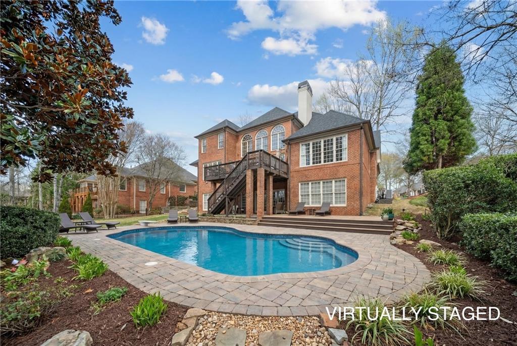 7105 Sheffield Place Cumming, GA 30040 - Photo 46 of 73 a view of a house with a swimming pool