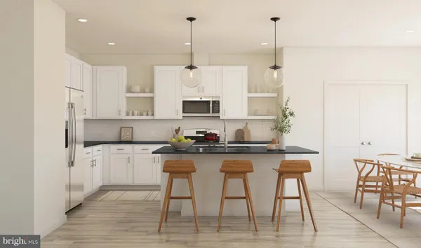 a kitchen with stainless steel appliances granite countertop a table chairs stove and white cabinets